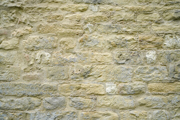 Stone wall bricked with strong structure, photographed in daylight