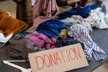 A heap of donation clothes on black wooden table