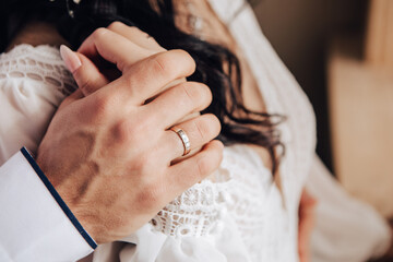 Husband and wife couple hugging at the photo session in studio. Wedding married bride and groom celebrate their engagement. Procreation romantic amazing lovers newlyweds indoor, copy space.
