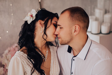 Husband and wife couple hugging at the photo session in studio. Wedding married bride and groom...
