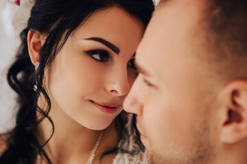 Husband and wife couple hugging at the photo session in studio. Wedding married bride and groom celebrate their engagement. Procreation romantic amazing lovers newlyweds indoor, copy space.