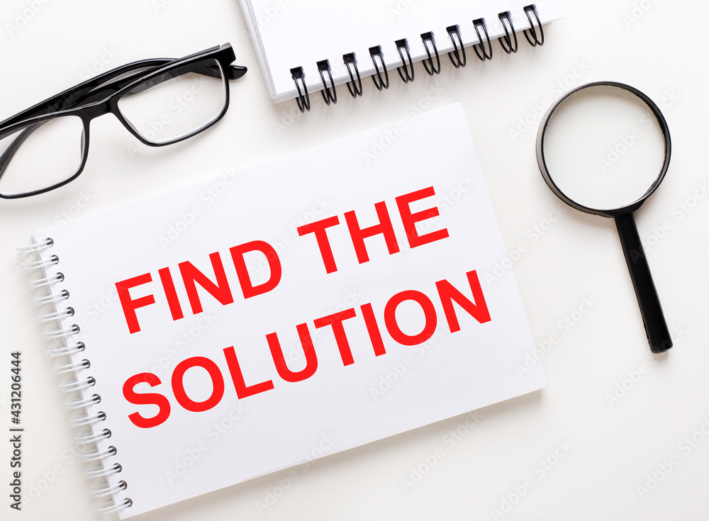Poster find the solution is written in a white notebook on a light background near the notebook, black-fram