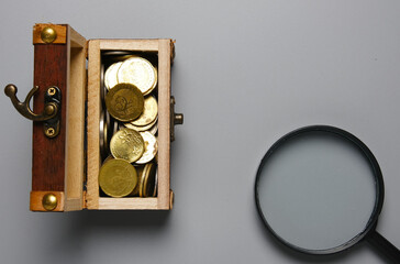 A picture gold chest with coin and magnifying glass. Finding your life purpose.