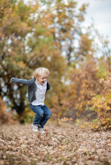 little child running in autumn park
