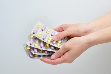 Male doctor hand holding pack of different tablet blisters at workplace closeup. Panacea, life save service, prescribe medicament, legal drug store, disease healing, blood pressure concept. 