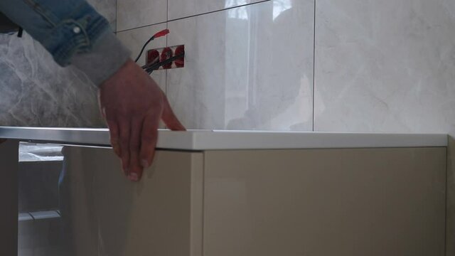 Furniture assembly. Carpenter fixing artificial stone table top. Kitchen and bathroom new furniture. House improving and repairing. handyman at work. collecting table joining parts together