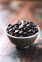 Coffee beans in a small ceramic dish. Close up.	