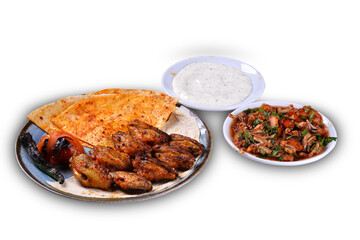 Traditional oriental chicken wing kebab and shashlik skewer with tomato, salad and flatbread on white background. Turkish traditional kebabs. (karisik kebap)