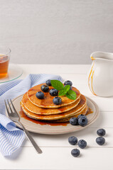 Stack of pancakes with fresh blueberry and caramel syrup