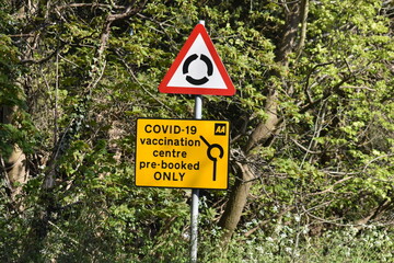 Vaccination centre directions on a street sign in Epping.