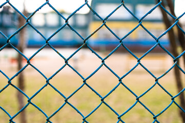 chain-link of blue color close-up, background is blured