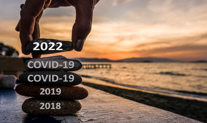 New Year 2022 is coming concept. Covid year 2021 to 2022 background. Positive turn of old year....