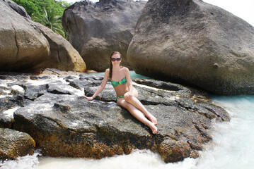 Young fashionable woman resting on the beach of paradise island.