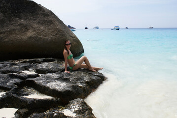 Young fashionable woman resting on the beach of paradise island.