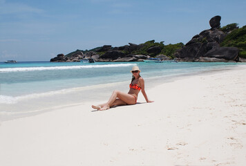 Young fashionable woman resting on the beach of paradise island.