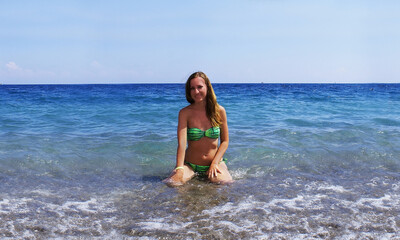 Fototapeta na wymiar Young fashionable woman resting on the beach of paradise island.