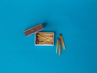 wooden matches on blue background