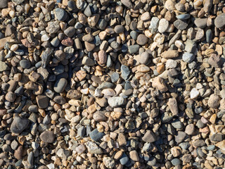 Textured background of colorful gravel stones. Empty space to insert.