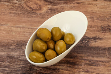 Green pickled olives in the bowl