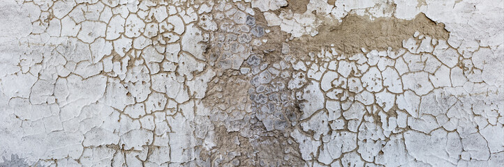 Old rustic grungy aged painted facade of rusty smudged daub. Rough grime edged wall. Wrinkled uneven plastering. Cracked chipped messy falling stucco.Dirty vintage flaking textured layer for 3D design