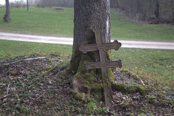 broken cross in a graveyard
