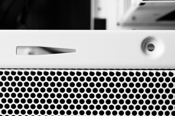 Horizontal ventilation grille. Round holes. Metal construction. Dark background. Front view...