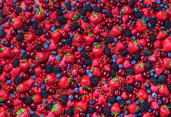 Berries overhead close-up vibrant healthy food ready to eat arrangement strawberries blackberries...