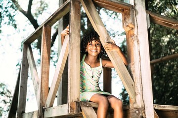 portrait of a small afro american girl sitting looking at the camera.