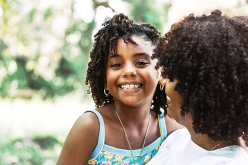 portrait of a little afro american girl looking at the camera smiling and happy.