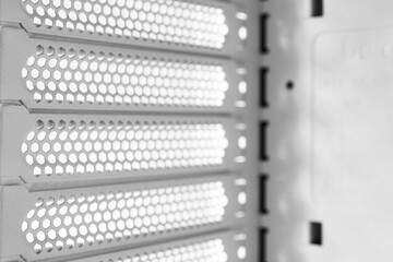 Horizontal ventilation grille. Air vents. Metal construction. Angle view. Black and white tones.