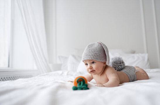 happy baby child in costume a rabbit bunny on a white background. High quality photo