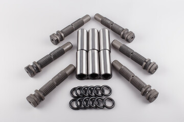 a set of bushing pins and gaskets for car repairs lie on a gray background. Repair kit for the...