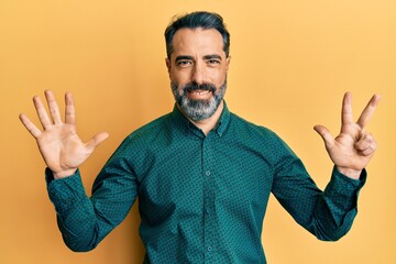 Middle age man with beard and grey hair wearing business clothes showing and pointing up with fingers number eight while smiling confident and happy.
