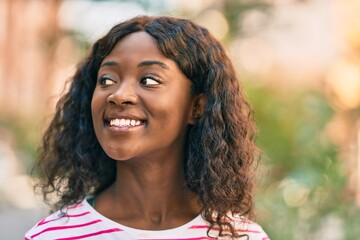 Young african american girl smiling happy standing at the city.