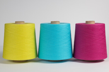 A set of three large multicolored cotton threads. Bright colored threads with even winding on white isolated background