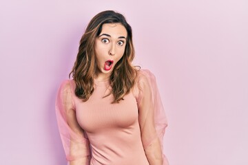 Young hispanic girl wearing casual clothes afraid and shocked with surprise expression, fear and excited face.
