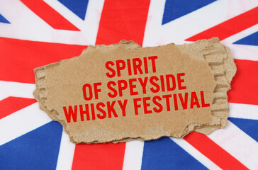 Fototapeta na wymiar Against the background of the flag of Great Britain lies cardboard with the inscription - Whisky Festival