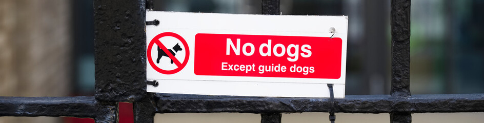 No dogs except guide dogs sign outside school
