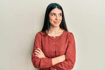 Fototapeta premium Young hispanic woman wearing casual clothes smiling looking to the side and staring away thinking.