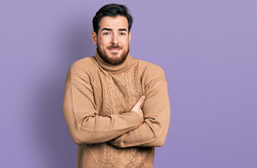 Obraz premium Young hispanic man wearing casual clothes shaking and freezing for winter cold with sad and shock expression on face