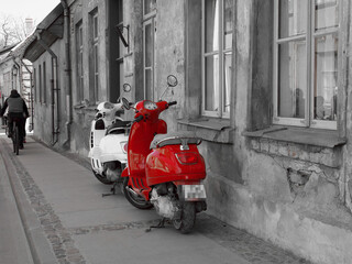White and red scooter on the street in the old city.