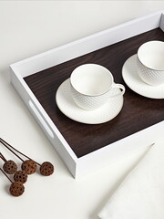Coffee on breakfast tray.White wooden tray with cups