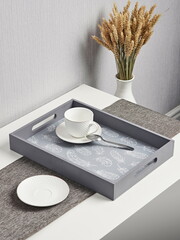 Coffee on breakfast tray. Grey wooden tray with cups
