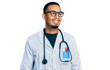 Young african american man wearing doctor uniform and stethoscope looking away to side with smile...