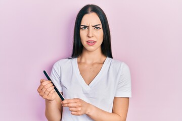 Beautiful woman with blue eyes using file nail clueless and confused expression. doubt concept.