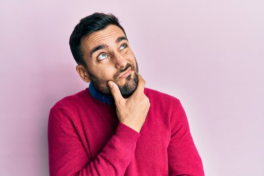 Young hispanic man wearing casual clothes thinking worried about a question, concerned and nervous with hand on chin