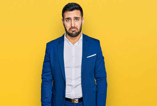 Young hispanic man wearing business jacket depressed and worry for distress, crying angry and afraid. sad expression.