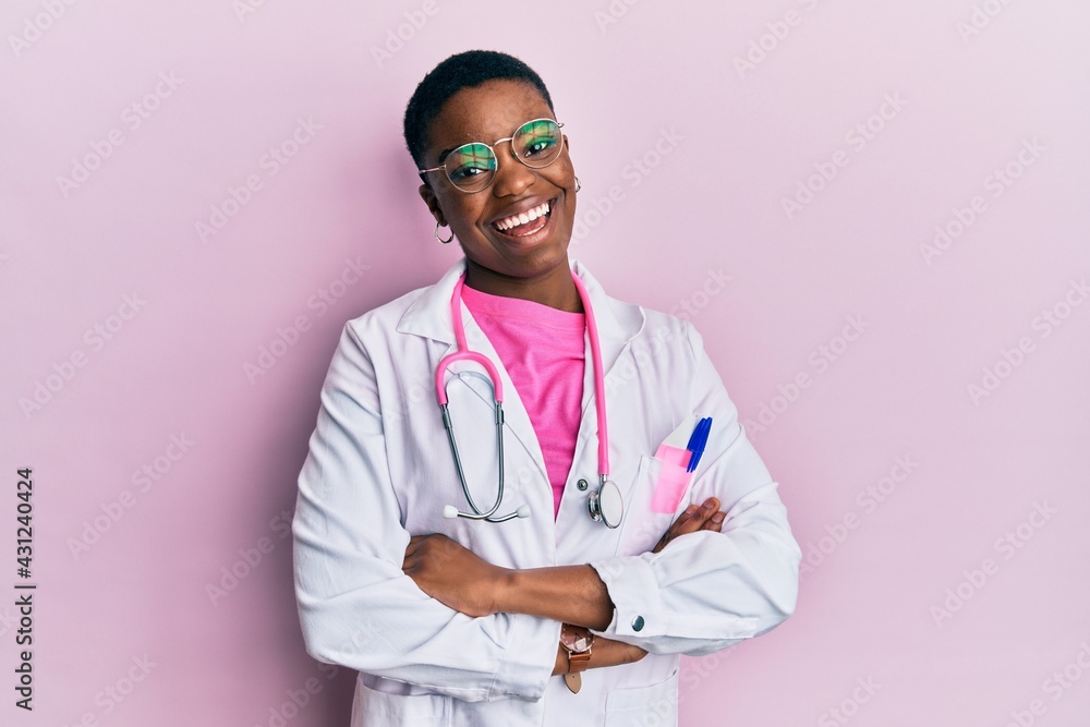 Canvas Prints Young african american woman wearing doctor uniform and stethoscope winking looking at the camera with sexy expression, cheerful and happy face.