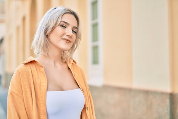 Naklejka premium Young blonde girl smiling happy standing at the city.