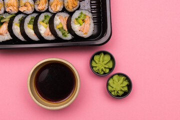 Sushi rolls on pink background, Japanese food